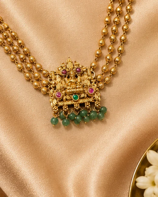 Antique-finish Lakshmi pendant with green bead drops